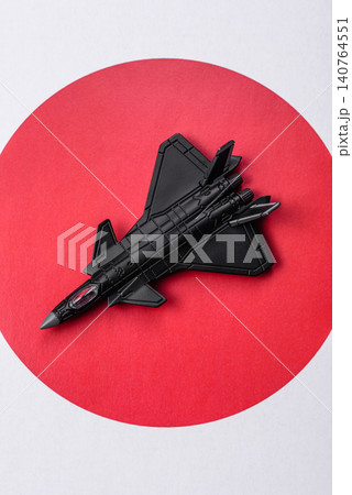 A fighter jet against the Japanese flag as a conceptual background representing defense A fighter jet against the Japanese flag as a conceptual background representing defense 140764551