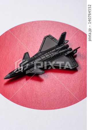 A fighter jet against the Japanese flag as a conceptual background representing defense A fighter jet against the Japanese flag as a conceptual background representing defense 140764552