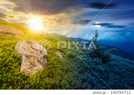 green landscape of mountain on summer solstice. view of rock among grass on the hillside. sun and moon in harmony over travel background and epic sky. mountain scenery with rolling hills green landscape of mountain on summer solstice. view of rock among grass on the hillside. sun and moon in harmony over travel background and epic sky. mountain scenery with rolling hills 140764712