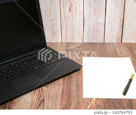 black laptop and sheet of paper with pen on table black laptop and sheet of paper with pen on table 140764791