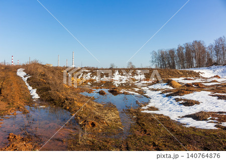 Spring melt unveils a dormant sand quarry, muddy pools and dirty snow patches hint at renewal amidst industrial backdrop Spring melt unveils a dormant sand quarry, muddy pools and dirty snow patches hint at renewal amidst industrial backdrop 140764876