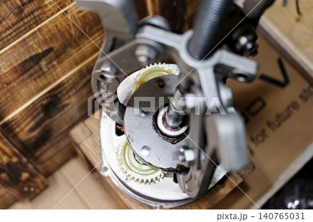 Mechanical puller removing the freewheel clutch from an electric bicycle geared hub motor during professional repair process inside a bike workshop setting close up Mechanical puller removing the freewheel clutch from an electric bicycle geared hub motor during professional repair process inside a bike workshop setting close up 140765031