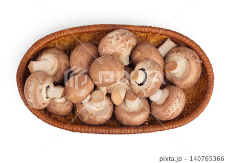 Brown champignon mushroom a wicker basket isolated on white background. Top view. Flat lay 140765366