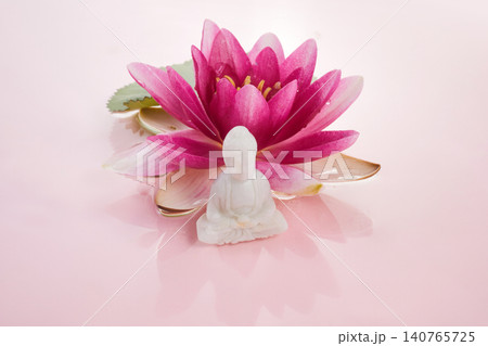 White buddha statue meditating on pink lotus flower 140765725