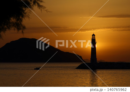 Seascape at sunshine. Lighthouse and sailings on the coast. Seaside town of Turgutreis and spectacular sunshine Seascape at sunshine. Lighthouse and sailings on the coast. Seaside town of Turgutreis and spectacular sunshine 140765962