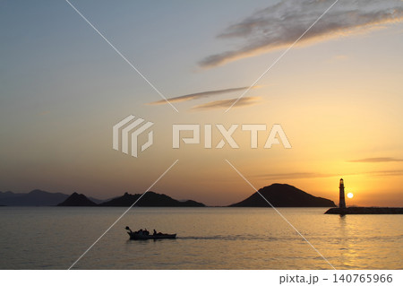 Seascape at sunshine. Lighthouse and sailings on the coast. Seaside town of Turgutreis and spectacular sunshine Seascape at sunshine. Lighthouse and sailings on the coast. Seaside town of Turgutreis and spectacular sunshine 140765966