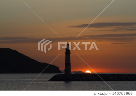 Seascape at sunshine. Lighthouse and sailings on the coast. Seaside town of Turgutreis and spectacular sunshine Seascape at sunshine. Lighthouse and sailings on the coast. Seaside town of Turgutreis and spectacular sunshine 140765969