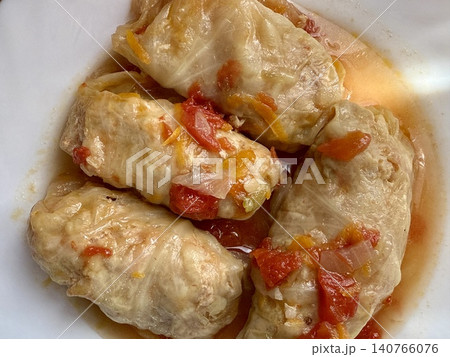 Cabbage rolls stewed in tomato sauce, cabbage leaves stuffed with meat and rice. Delicious and healthy home cooking. 140766076