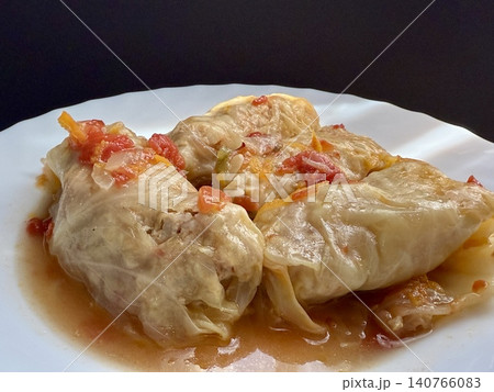 Cabbage rolls stewed in tomato sauce, cabbage leaves stuffed with meat and rice. Delicious and healthy home cooking. 140766083