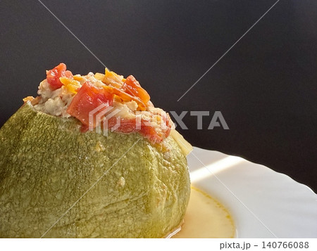 Zucchini stuffed with meat and rice, stewed in tomato sauce. Delicious and healthy home cooking. 140766088