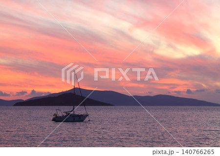 Alone sailboat at sunset. Atmospheric seascape with reflection Alone sailboat at sunset. Atmospheric seascape with reflection 140766265