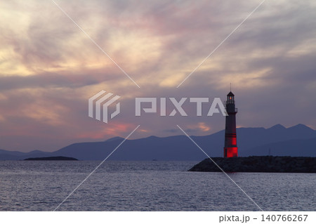 Seascape at sunshine. Lighthouse and sailings on the coast. Seaside town of Turgutreis and spectacular sunshine Seascape at sunshine. Lighthouse and sailings on the coast. Seaside town of Turgutreis and spectacular sunshine 140766267