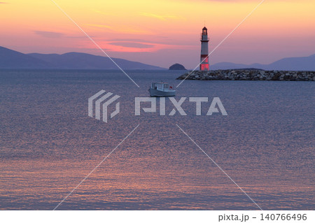 Seascape at sunshine. Lighthouse and sailings on the coast. Seaside town of Turgutreis and spectacular sunshine Seascape at sunshine. Lighthouse and sailings on the coast. Seaside town of Turgutreis and spectacular sunshine 140766496