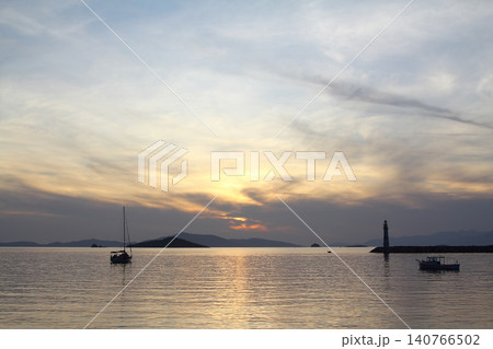 Seascape at sunshine. Lighthouse and sailings on the coast. Seaside town of Turgutreis and spectacular sunshine 140766502