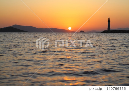 Seascape at sunshine. Lighthouse and sailings on the coast. Seaside town of Turgutreis and spectacular sunshine 140766536