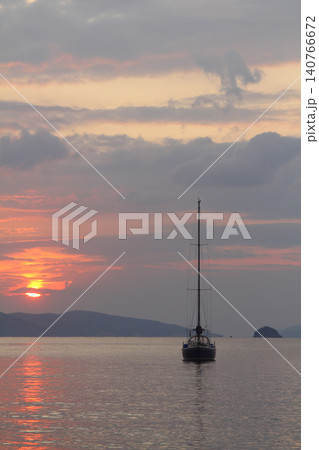 Alone sailboat at sunset. Atmospheric seascape with reflection Alone sailboat at sunset. Atmospheric seascape with reflection 140766672