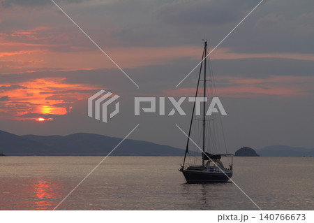 Alone sailboat at sunset. Atmospheric seascape with reflection Alone sailboat at sunset. Atmospheric seascape with reflection 140766673