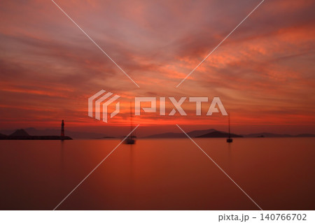 Seascape at sunshine. Lighthouse and sailings on the coast. Seaside town of Turgutreis and spectacular sunshine Seascape at sunshine. Lighthouse and sailings on the coast. Seaside town of Turgutreis and spectacular sunshine 140766702