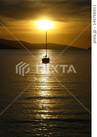 Alone sailboat at sunset. Atmospheric seascape with reflection 140766911