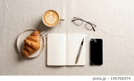 Top down view of notebook with pen and morning breakfast essentials notebook croissant smartphone eyeglasses breakfast stationery organizer business planning tablecloth minimalist overhead Top down view of notebook with pen and morning breakfast essentials notebook croissant smartphone eyeglasses breakfast stationery organizer business planning tablecloth minimalist overhead 140766974