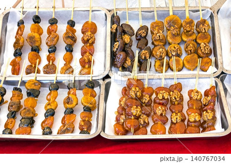 Dry sweet food on skewer sticks 140767034