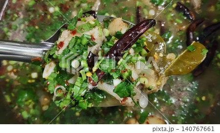 Close-up of Spicy and Sour Thai Pork Rib Soup Tom Saap with Herbs Close-up of Spicy and Sour Thai Pork Rib Soup Tom Saap with Herbs 140767661