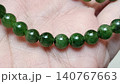Natural Dark Green Jade Gemstone Round Bead Bracelet on Human Palm 140767663