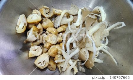 Fresh Mixed Sliced Straw and Oyster Mushrooms in a Stainless Steel Bowl Fresh Mixed Sliced Straw and Oyster Mushrooms in a Stainless Steel Bowl 140767666