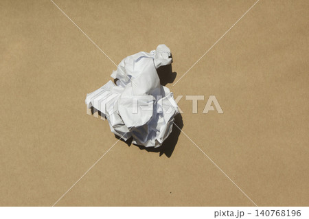 Crumpled paper isolated on brown background . Crumpled paper isolated on brown background . 140768196