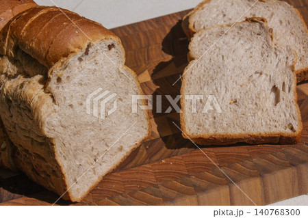 It is a slice of bread placed on a wooden cutting board. 140768300