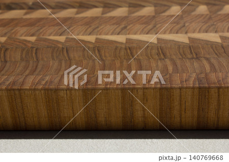 This is a patterned wooden cutting board. This is a patterned wooden cutting board. 140769668