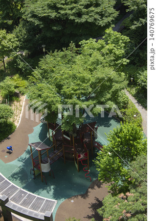 It is a playground with lush trees. It is a playground with lush trees. 140769675