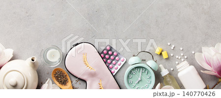 Sleep Wellness Setup with Mask, Pills and Alarm Clock on Soft Background 140770426