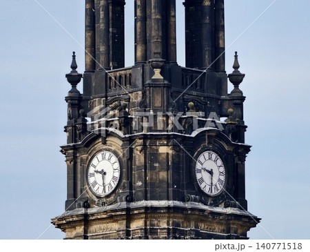 Sandstone clock with intricate craftsmanship. Architectural features of historic sandstone clock tower Sandstone clock with intricate craftsmanship. Architectural features of historic sandstone clock tower 140771518