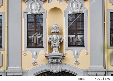 Elegant historic facade. Architectural design showcasing detailed reliefs and symmetrical features Elegant historic facade. Architectural design showcasing detailed reliefs and symmetrical features 140771520