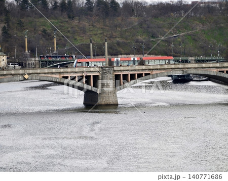 Vibrant urban transit. Industrial daytime scene with flowing river and bustling infrastructure Vibrant urban transit. Industrial daytime scene with flowing river and bustling infrastructure 140771686