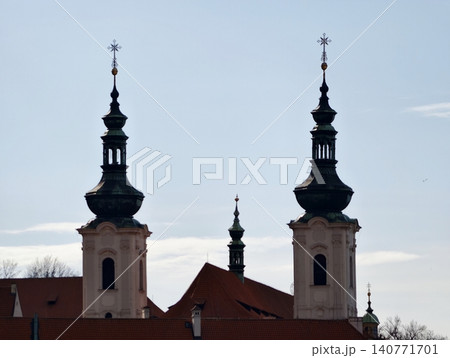 Old town bells echo serenity. Colorful rooftops and twin spires create gentle historical ambiance 140771701