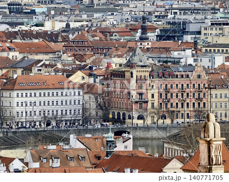 Historic city sight. Gothic structures with lively crowds and scenic waterside scenery for tourism Historic city sight. Gothic structures with lively crowds and scenic waterside scenery for tourism 140771705