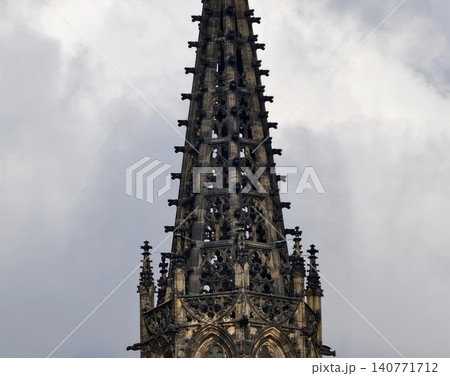 Gothic tower grandeur. Vertical gothic architecture showcasing historic artistry and elaborate tracery Gothic tower grandeur. Vertical gothic architecture showcasing historic artistry and elaborate tracery 140771712