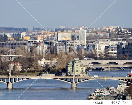 Urban river landscape. Contemporary bridges over calm water. Cityscape with twin bridges and modern buildings 140771725