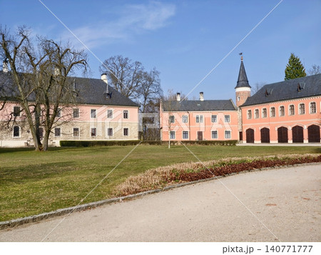 Elegant garden entrance. Graceful curved road leads to historic estate entrance with scenic surroundings Elegant garden entrance. Graceful curved road leads to historic estate entrance with scenic surroundings 140771777