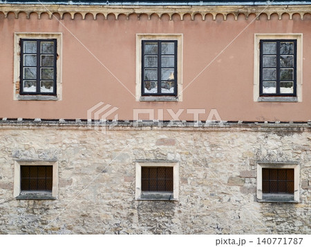 Solid stone foundation with small slit windows and rugged exterior suitable for structural analysis Solid stone foundation with small slit windows and rugged exterior suitable for structural analysis 140771787