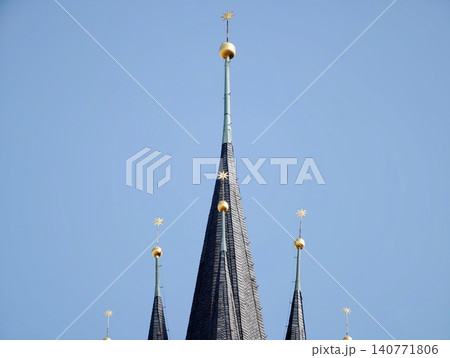 Graceful needleshaped tower reaching skyward with reflective surfaces and artistic craftsmanship Graceful needleshaped tower reaching skyward with reflective surfaces and artistic craftsmanship 140771806