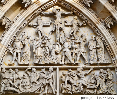 Decorative religious sculpture. Intricate high relief carving depicting crucifixion scene in cathedral 140771855