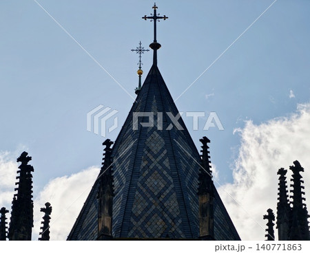 Photographer captures intricate Gothic roof details with dramatic lighting and historic ambiance Photographer captures intricate Gothic roof details with dramatic lighting and historic ambiance 140771863