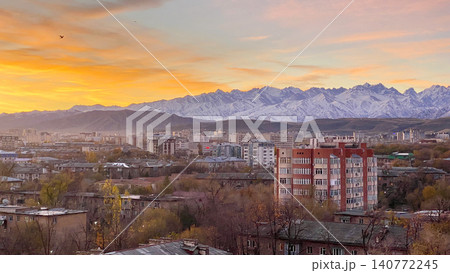Stunning scenic sunrise in Bishkek city with views of mountain ranges and peaks. Autumn in Kyrgyzstan. Morning in the city. Stunning scenic sunrise in Bishkek city with views of mountain ranges and peaks. Autumn in Kyrgyzstan. Morning in the city. 140772245