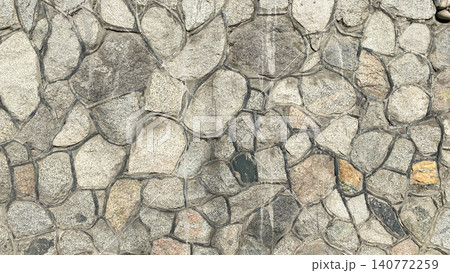A wall of stones of different sizes and colors. Beautiful texture of stone masonry with veins. A wall of stones of different sizes and colors. Beautiful texture of stone masonry with veins. 140772259