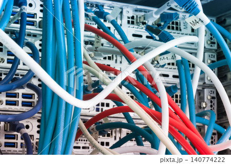 Fiber Optic cables connected to optic ports, network cables conn 140774222