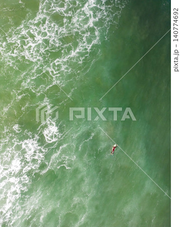 Surfer in the wavy sea Surfer in the wavy sea 140774692