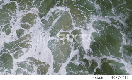 Overhead view of waves crashing on sandy beach Overhead view of waves crashing on sandy beach 140774711